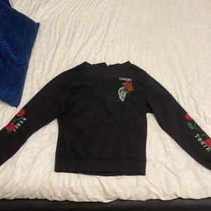 black hoodie with rose on chest and arms
